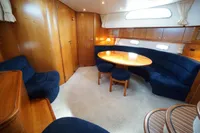 Luxurious interior of 2004 Elling E3 Ultimate yacht with blue seating and wooden accents.