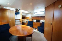 Luxurious interior of 2004 Elling E3 Ultimate yacht with wooden furnishings and cozy seating.