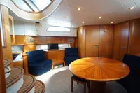 Luxurious interior of 2004 Elling E3 Ultimate yacht with wooden furnishings and seating area.