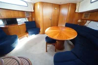 Luxurious 2004 Elling E3 Ultimate yacht interior with wooden furnishings and blue seating.