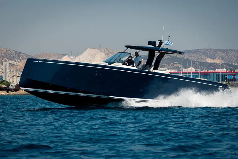 M/y Fizzy Yacht Photos Pics 2021 Pardo 43 yacht cruising on blue waters near a coastal city.