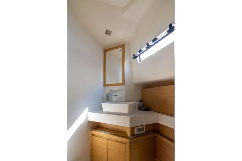 M/y Fizzy Yacht Photos Pics Modern bathroom interior on 2021 Pardo 43 yacht, featuring sleek sink and wooden cabinetry.