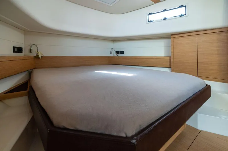 M/y Fizzy Yacht Photos Pics Interior cabin of 2021 Pardo 43 yacht with modern wood finish and cozy bed.