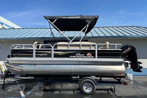 2022 Sun Tracker Bass Buggy 18 DLX pontoon boat on trailer, with Mercury outboard motor.