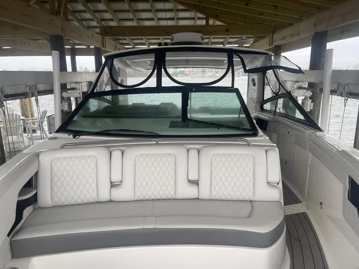 Sea Ray Slx 400 3x Mercury Ob Yacht Photos Pics 2022 Sea Ray SLX 400 boat with luxurious seating under a covered dock.