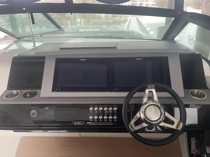 Sea Ray Slx 400 3x Mercury Ob Yacht Photos Pics Control panel of 2022 Sea Ray SLX 400 boat with dual Simrad displays and steering wheel.