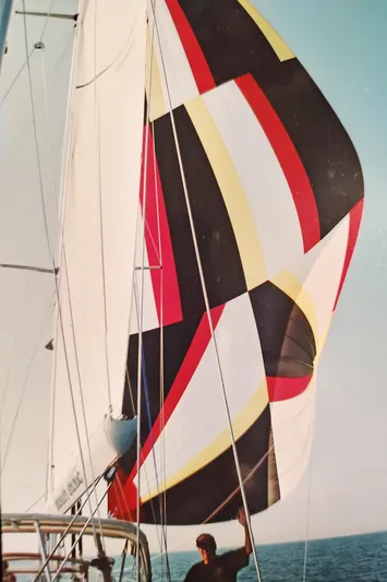 Dragon Dance Yacht Photos Pics Sailing yacht Tayana 55 (2001) with colorful spinnaker sail on open water.