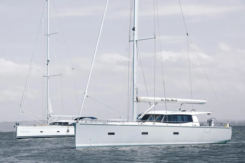  Yacht Photos Pics Modern Moody DS 54 sailboats on calm sea, 2026 model, under cloudy sky.