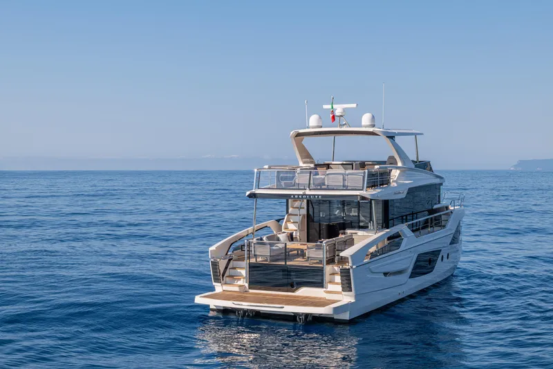  Yacht Photos Pics 2026 Absolute Navetta 62 yacht cruising on open sea under clear blue sky.