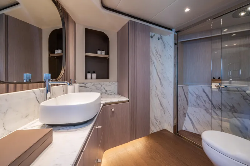  Yacht Photos Pics Luxurious bathroom in 2026 Absolute Navetta 62 yacht with marble accents and modern fixtures.