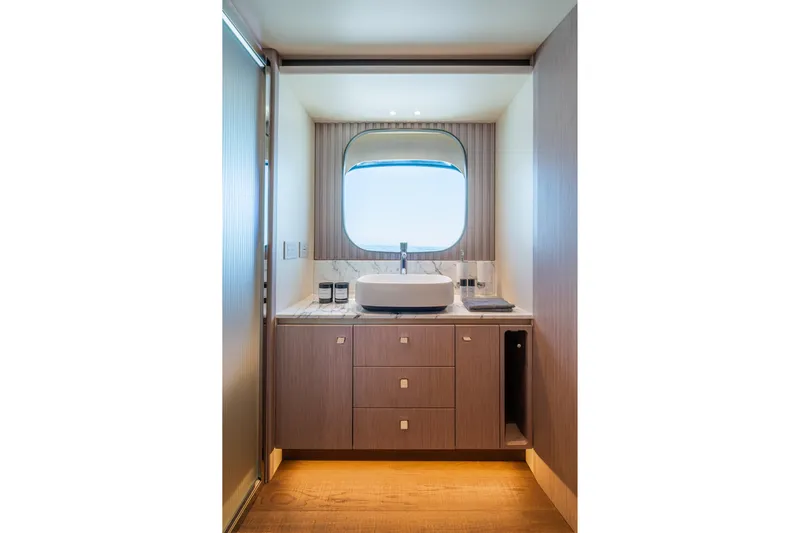  Yacht Photos Pics Luxurious bathroom interior of 2026 Absolute Navetta 62 yacht with modern sink and window view.