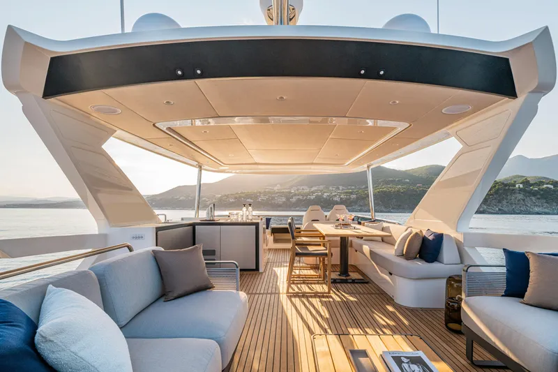  Yacht Photos Pics Luxurious 2026 Absolute Navetta 62 yacht deck with elegant seating and scenic ocean view.
