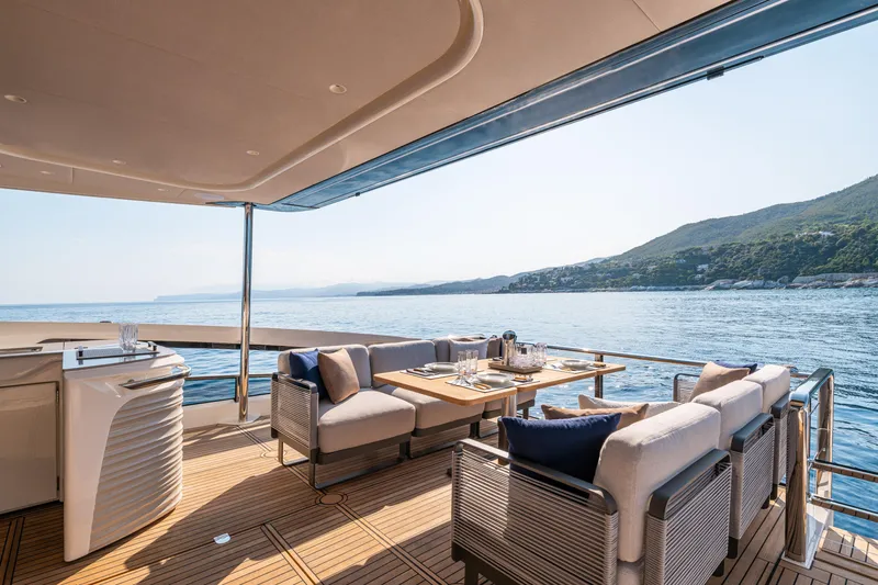  Yacht Photos Pics Luxurious deck of 2026 Absolute Navetta 62 yacht with ocean view and elegant seating.