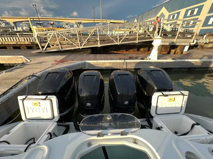 Saltwater Lady Yacht Photos Pics 2016 Yellowfin 42 boat with four powerful outboard engines docked at a marina.