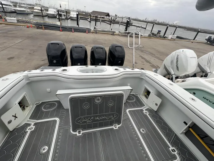 Saltwater Lady Yacht Photos Pics 2016 Yellowfin 42 boat with four outboard engines docked at a marina.