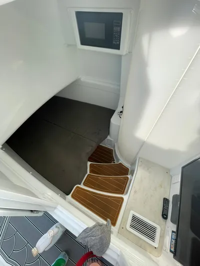 Saltwater Lady Yacht Photos Pics Interior of 2016 Yellowfin 42 boat with wooden steps and built-in microwave.