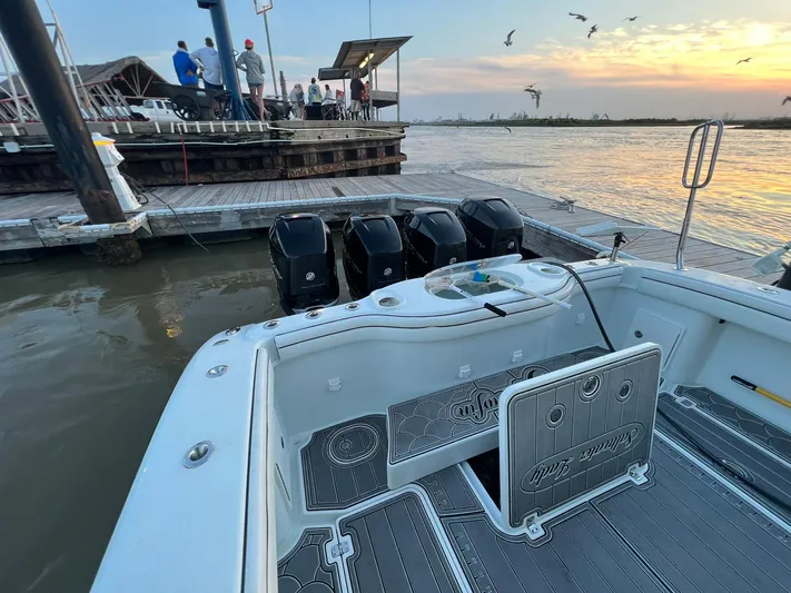 Saltwater Lady Yacht Photos Pics 2016 Yellowfin 42 boat docked at sunset with triple outboard engines.
