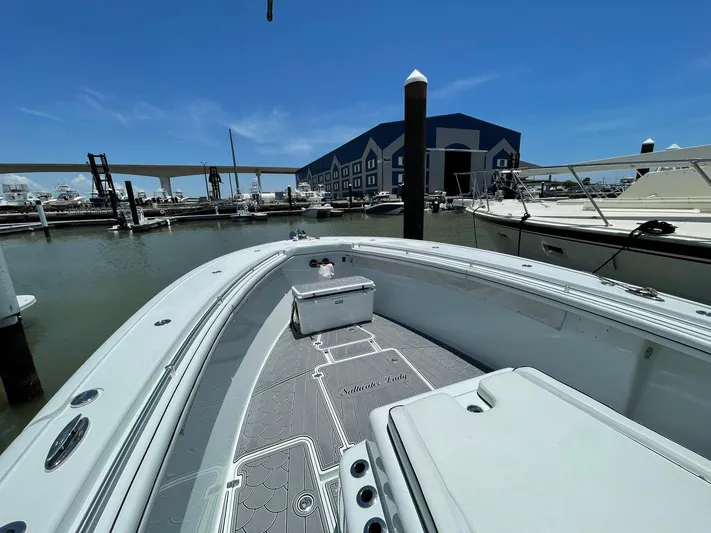 Saltwater Lady Yacht Photos Pics 2016 Yellowfin 42 boat docked at marina under clear blue sky.