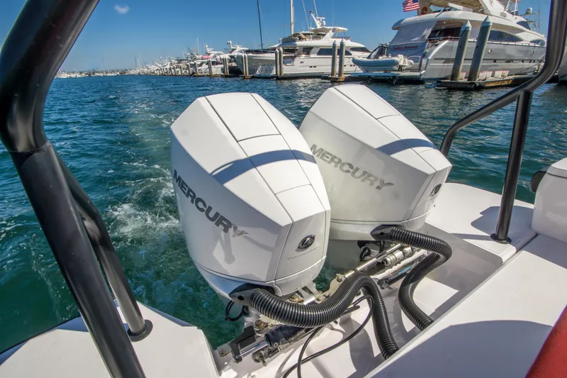  Yacht Photos Pics Twin Mercury outboard engines on a 2022 Axopar 28 Cabin boat in a marina.