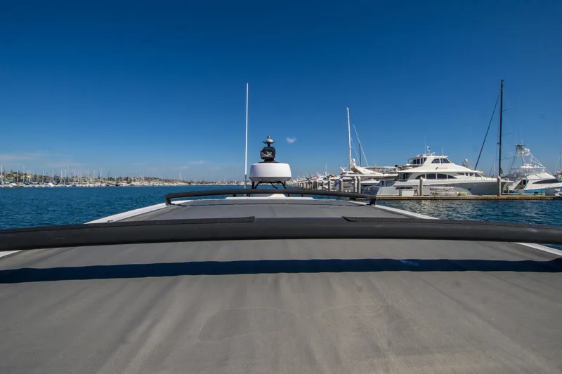  Yacht Photos Pics 2022 Axopar 28 Cabin boat docked in a marina under clear blue skies.