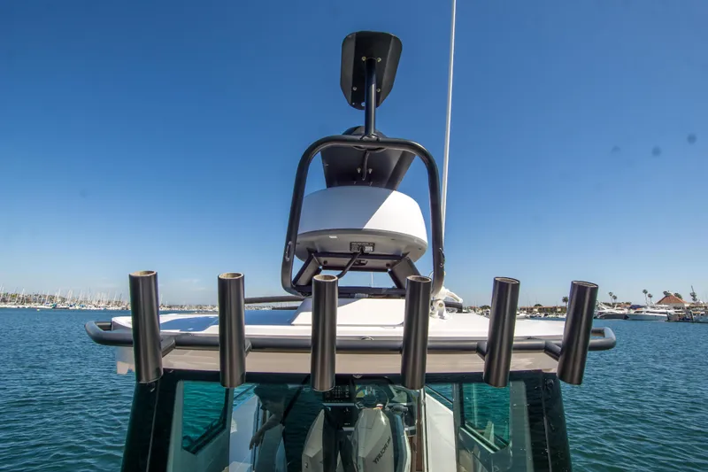  Yacht Photos Pics 2022 Axopar 28 Cabin boat with radar and rod holders on a sunny day.