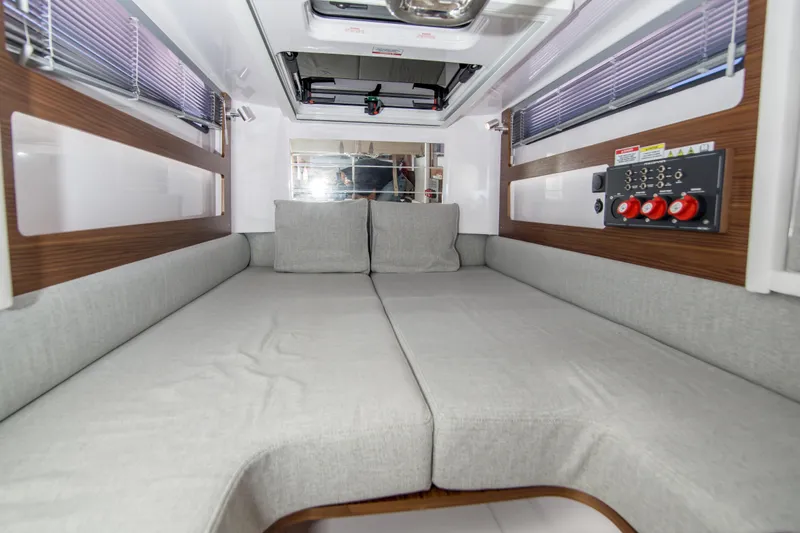  Yacht Photos Pics Interior of 2022 Axopar 28 Cabin with comfortable seating and control panel.