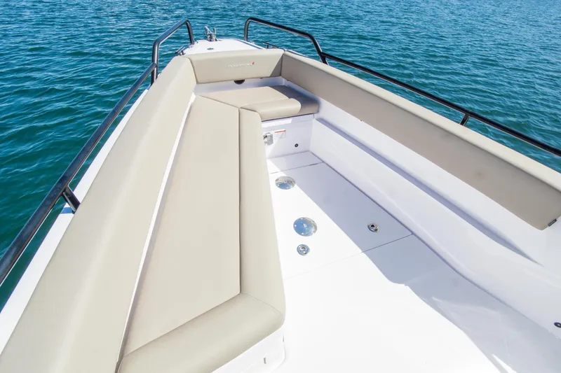  Yacht Photos Pics 2022 Axopar 28 Cabin boat with beige seating, on calm blue water.