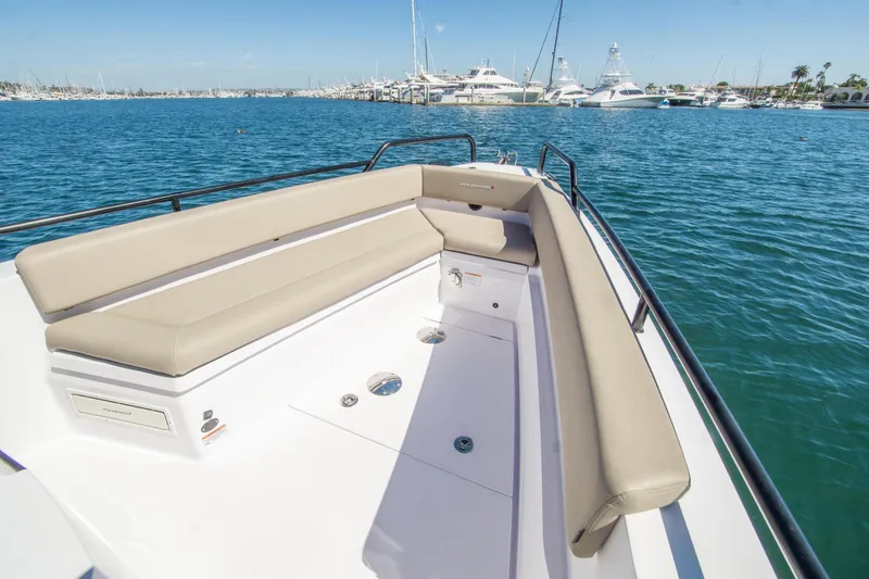  Yacht Photos Pics 2022 Axopar 28 Cabin boat with spacious seating, docked in a marina.