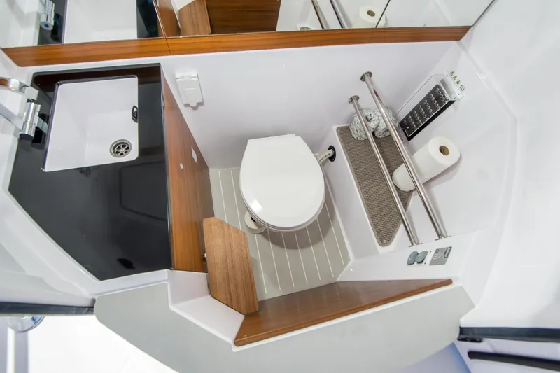  Yacht Photos Pics 2022 Axopar 28 Cabin bathroom with modern sink and toilet design.