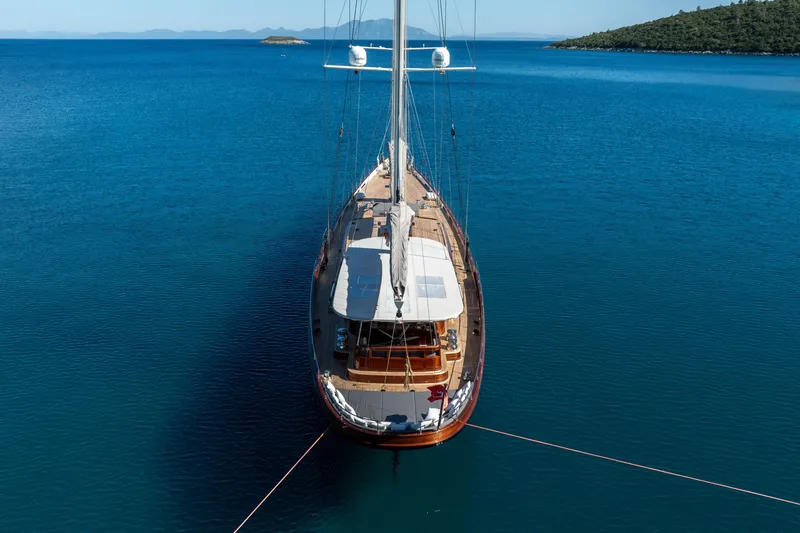 Sallyna Yacht Photos Pics Luxurious 2023 Su Marine sailing yacht anchored in serene blue waters.