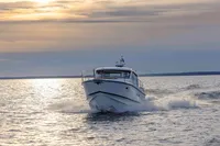 2024 Nimbus 365 Coupe cruising on open water at sunset.