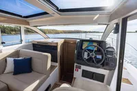 Interior of 2024 Nimbus 365 Coupe boat with modern helm and seating area.
