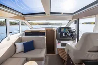 Interior of 2024 Nimbus 365 Coupe boat with modern helm and seating area.