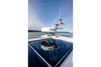 2024 Nimbus 365 Coupe boat with radar and flag on a sunny day.