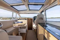 Interior of 2024 Nimbus 365 Coupe boat with modern design and panoramic windows.
