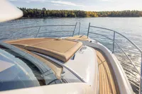 2024 Nimbus 365 Coupe yacht with sun deck, cruising on serene waters.
