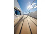 Side deck view of 2024 Nimbus 365 Coupe yacht under clear blue sky.