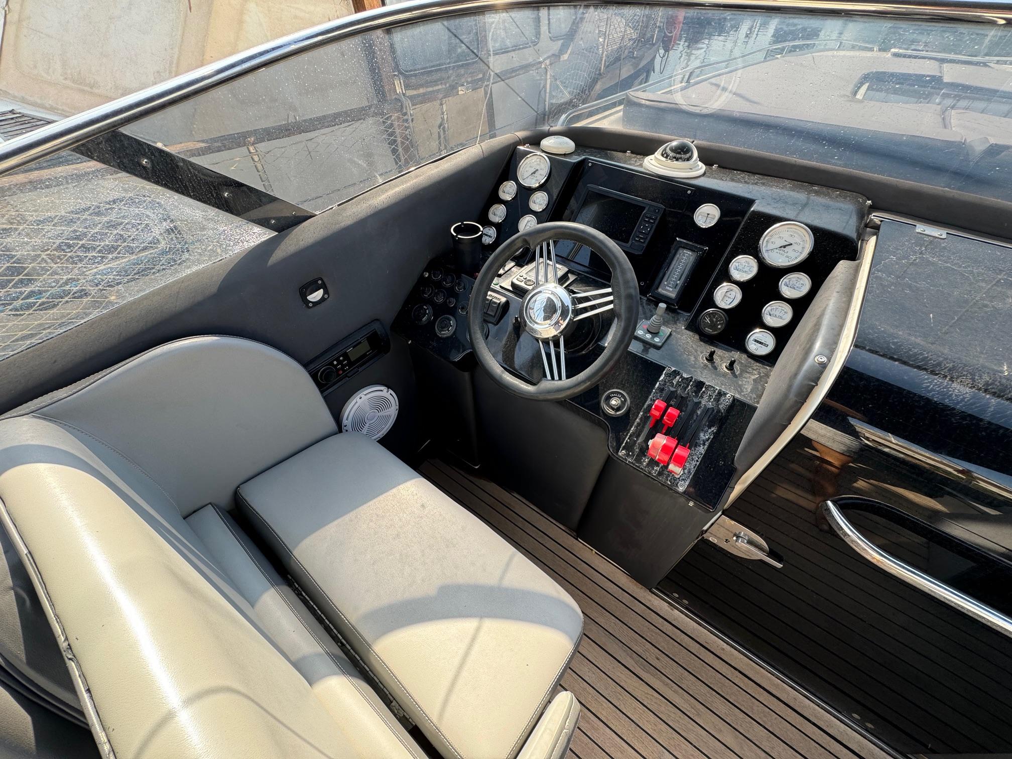 Cockpit of a 1997 Performance 1107 boat with steering wheel and control panel.