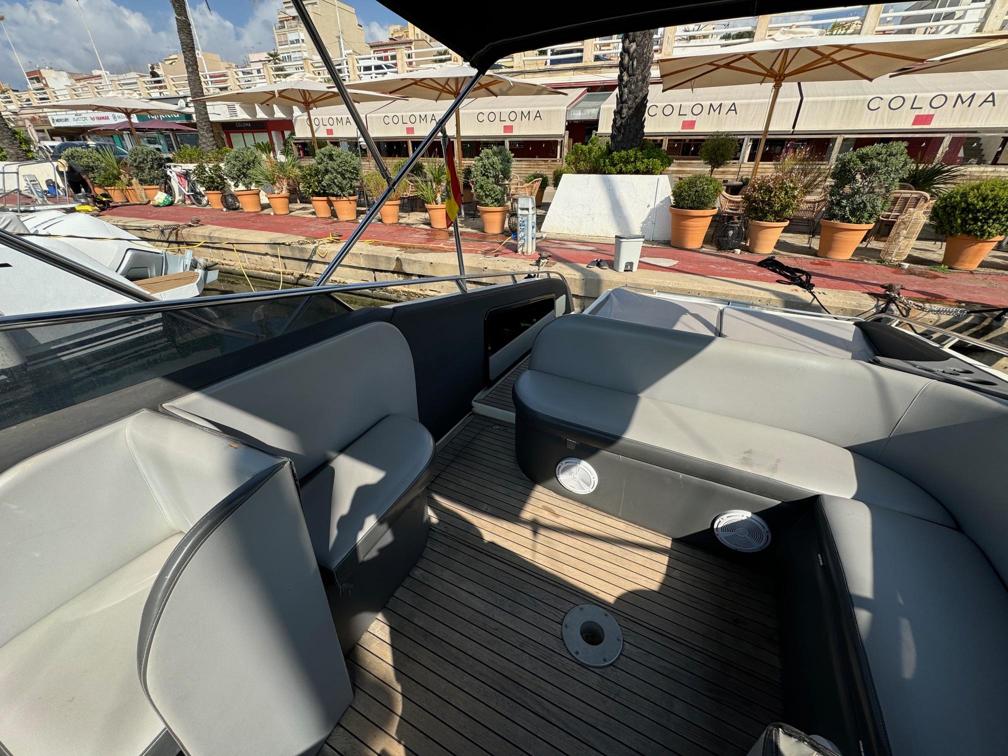 Luxurious 1997 Performance 1107 boat interior with sleek seating and wooden deck.