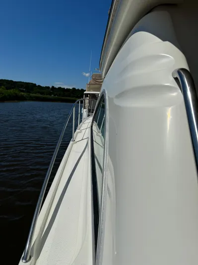 Jjetsdream Yacht Photos Pics 1999 Maxum 4600 SCB yacht side view on calm water under clear blue sky.