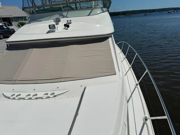 Jjetsdream Yacht Photos Pics 1999 Maxum 4600 SCB yacht docked by the water on a sunny day.