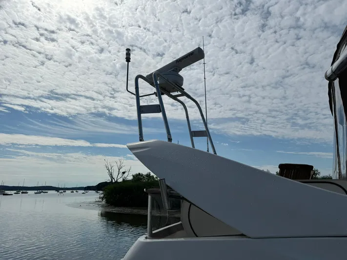 Jjetsdream Yacht Photos Pics 1999 Maxum 4600 SCB yacht against a cloudy sky on a calm waterway.