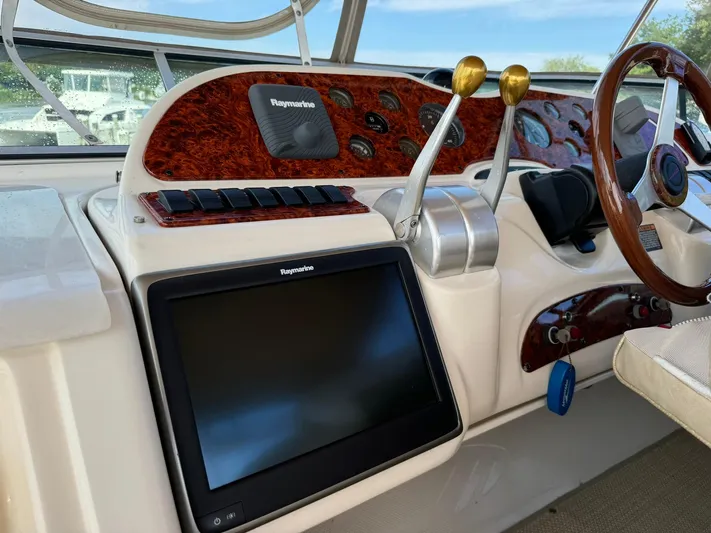 Jjetsdream Yacht Photos Pics 1999 Maxum 4600 SCB helm with Raymarine display and dual throttle controls.