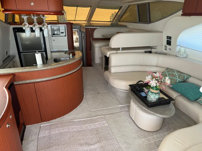 Jjetsdream Yacht Photos Pics Luxurious interior of 1999 Maxum 4600 SCB yacht with modern kitchen and seating area.