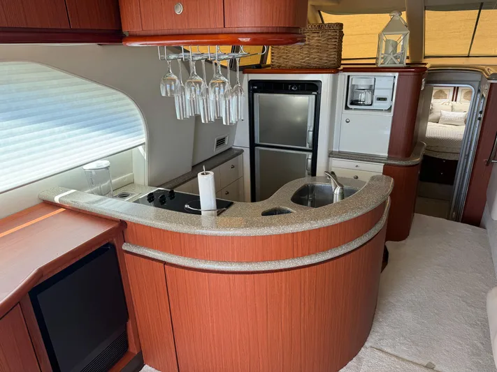 Jjetsdream Yacht Photos Pics Luxurious 1999 Maxum 4600 SCB yacht interior with modern kitchen and elegant wood finishes.