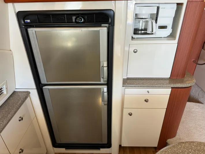 Jjetsdream Yacht Photos Pics 1999 Maxum 4600 SCB yacht kitchen with fridge, cabinets, and coffee maker.