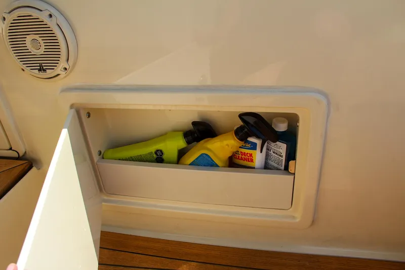 Phoenix Yacht Photos Pics Storage compartment on 2017 Chris-Craft Launch 36 with cleaning supplies.