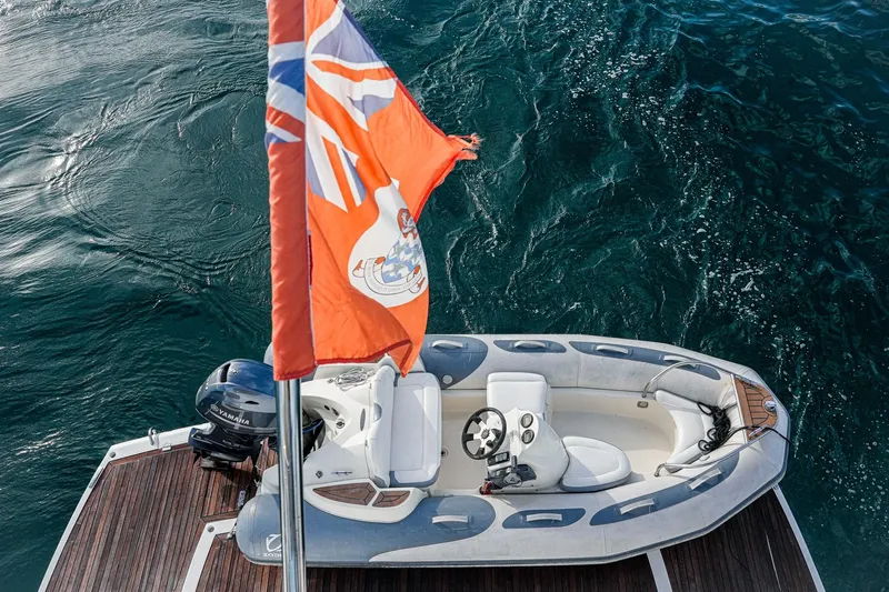 Solaire Yacht Photos Pics Aerial view of a Sunseeker 76 Yacht's tender boat with flag, 2019 model.