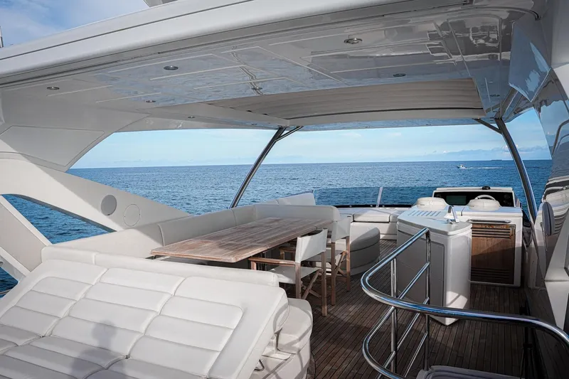 Solaire Yacht Photos Pics Luxurious 2019 Sunseeker 76 Yacht deck with seating, dining area, and ocean view.