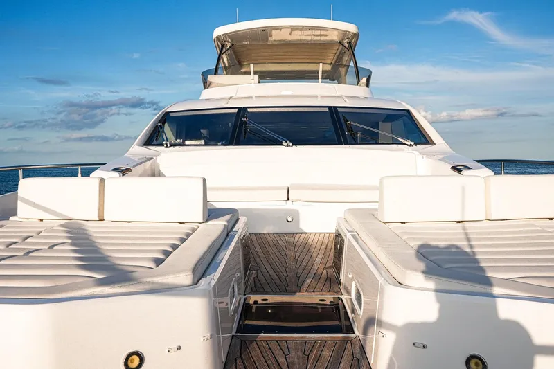 Solaire Yacht Photos Pics 2019 Sunseeker 76 Yacht with luxurious deck and seating, under a clear blue sky.